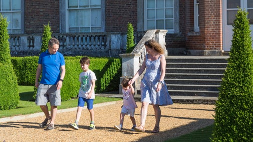 A family walk in the Parterre in July at Wimpole Estate, Cambridgeshire